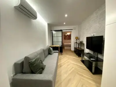 Una televisión o centro de entretenimiento en Apartamento Tibidabo Int con Parking