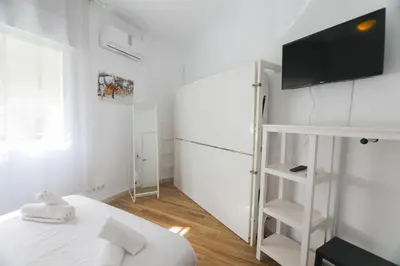 Cama o camas de una habitación en RentalSevilla Espacioso y acogegor apartamento de 3 dormitorios