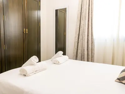 Cama o camas de una habitación en Tejares Suite Cordoba
