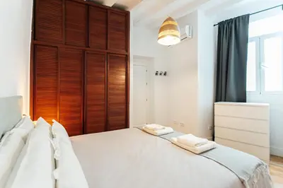 Cama o camas de una habitación en Peral Suite Sevilla
