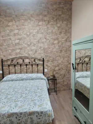 Cama o camas de una habitación en La Plazuela, casa andaluza con patio.