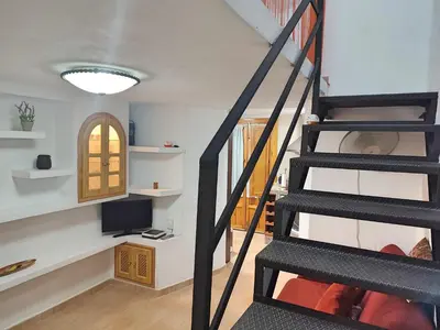Una televisión o centro de entretenimiento en Apartamento Dama de Noche