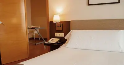 Cama o camas de una habitación en Vértice Sevilla