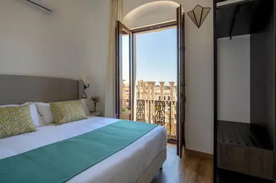 Cama o camas de una habitación en Coliseum Boutique Apartments