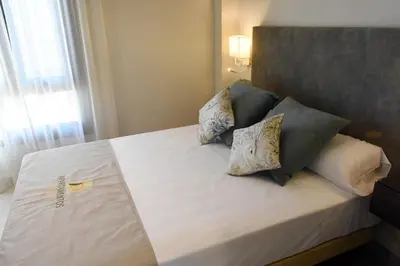 Cama o camas de una habitación en APTOS MILLÁN