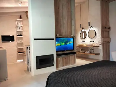 Una televisión o centro de entretenimiento en Apartamento Caolin Rocabella