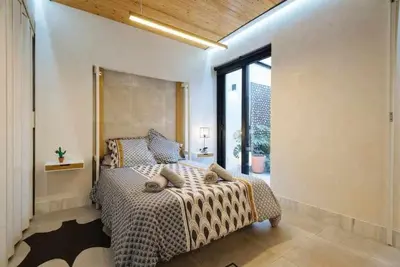 Cama o camas de una habitación en Lujoso loft con piscina y espacio office