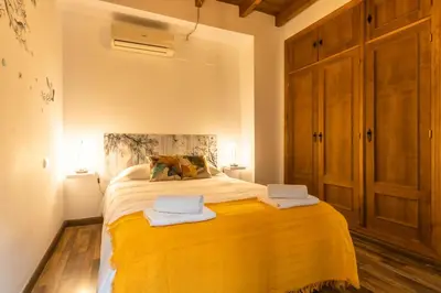 Cama o camas de una habitación en APARTAMENTO PATIO ANDALUZ EN SEVILLA