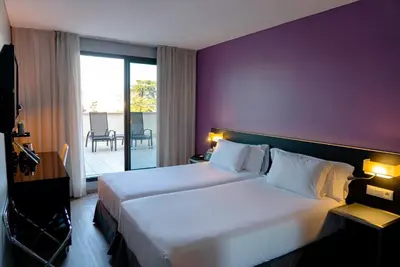 Cama o camas de una habitación en Sercotel Córdoba Medina Azahara