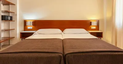 Cama o camas de una habitación en Apartamentos Vértice Bib Rambla