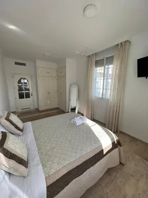 Cama o camas de una habitación en ATICO SUITE CLAUDIO MARCELO