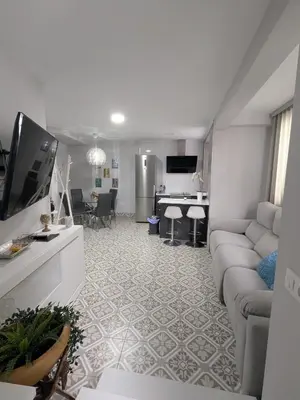 Una televisión o centro de entretenimiento en Génesis - Apartamento en Baena