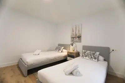 Cama o camas de una habitación en RentalSevilla San Esteban