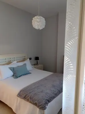 Cama o camas de una habitación en APARTAMENTOS TURISTICOS LAS CINCO JOYAS