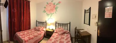 Cama o camas de una habitación en Hotel Las Rosas