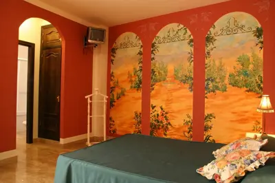 Cama o camas de una habitación en Hotel Las Rosas