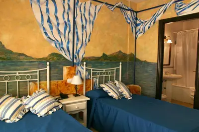 Cama o camas de una habitación en Hotel Las Rosas