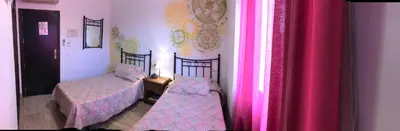 Cama o camas de una habitación en Hotel Las Rosas