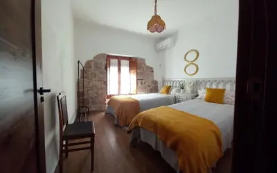 Cama o camas de una habitación en La Casa del Abuelo Curro