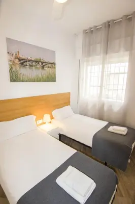 Cama o camas de una habitación en RentalSevilla Plaza de Pilatos