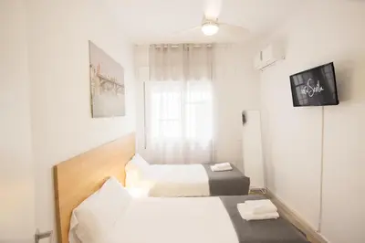 Cama o camas de una habitación en RentalSevilla Plaza de Pilatos